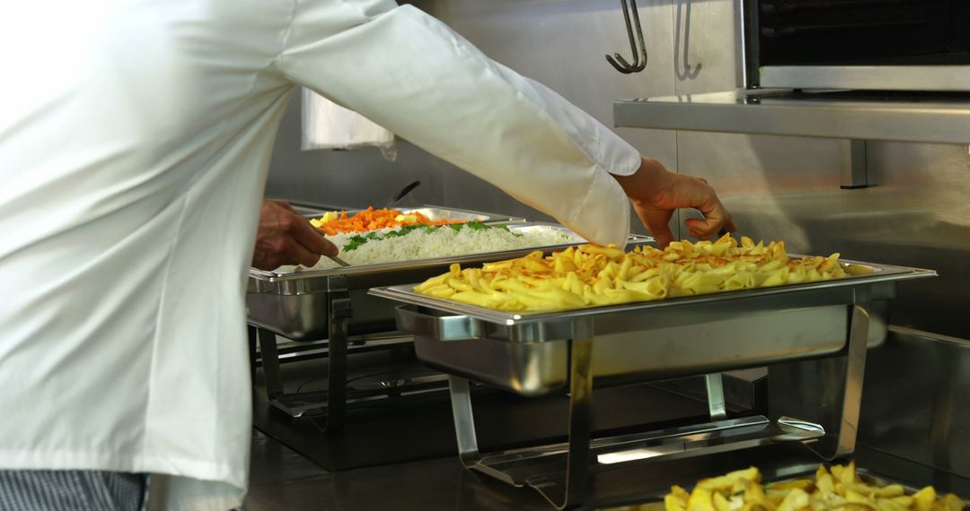 Chef Arranging Food Trays In Professional Kitchen - Free Images, Stock Photos and Pictures on Pikwizard.com