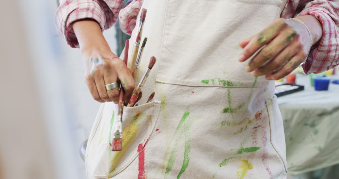 Close-Up of Painter's Apron with Brushes and Paint Stains - Free Images, Stock Photos and Pictures on Pikwizard.com