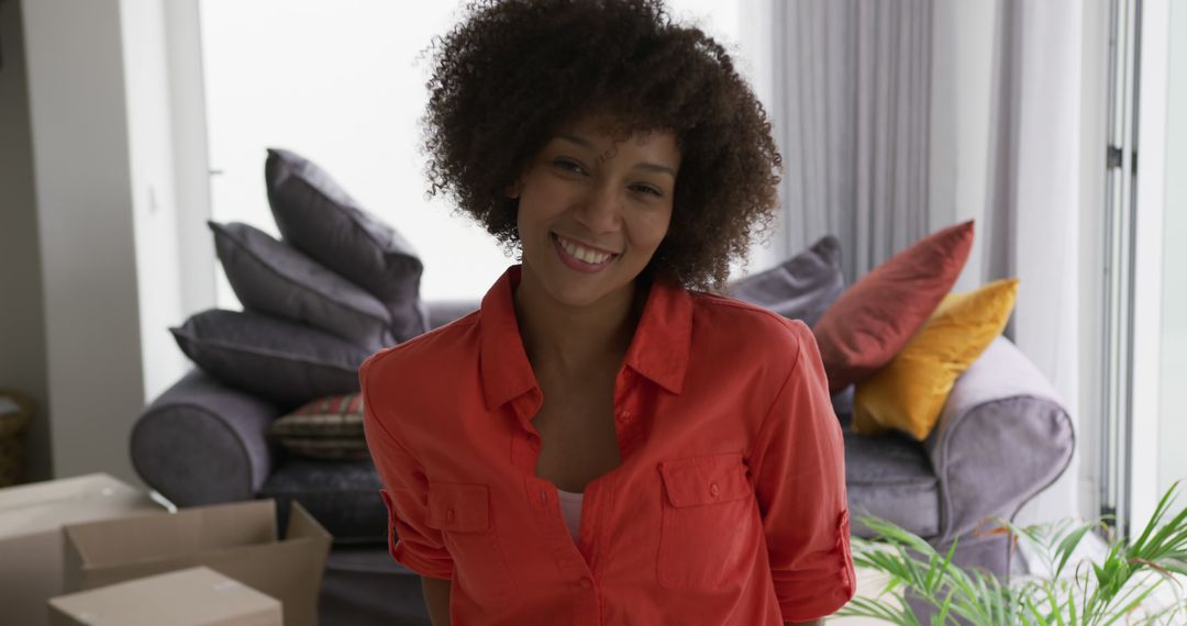 Smiling Woman Unpacking Boxes in New Home - Free Images, Stock Photos and Pictures on Pikwizard.com