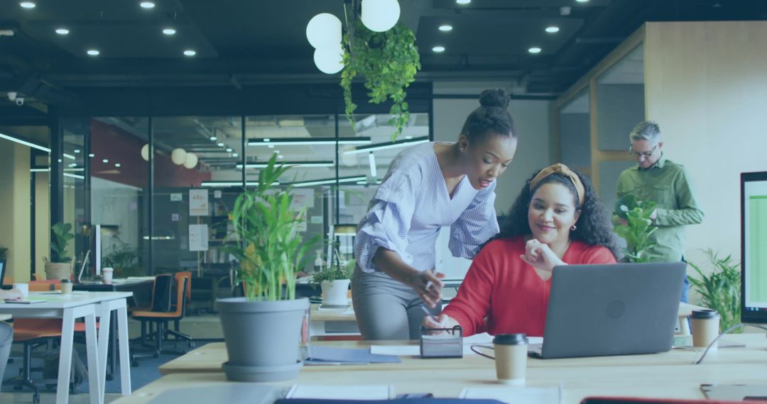 Dynamic Workplace with Diverse Team Overseeing Project on Laptop