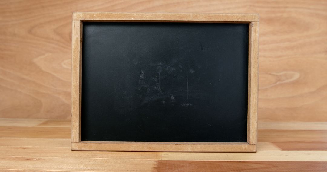 Empty Chalkboard with Wooden Frame on Wooden Table - Free Images, Stock Photos and Pictures on Pikwizard.com