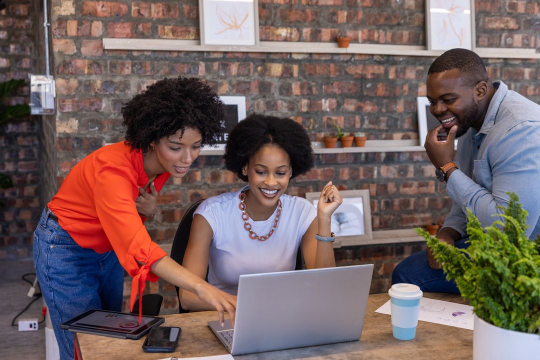 Diverse Team Collaborating in Creative Office Space with Technology