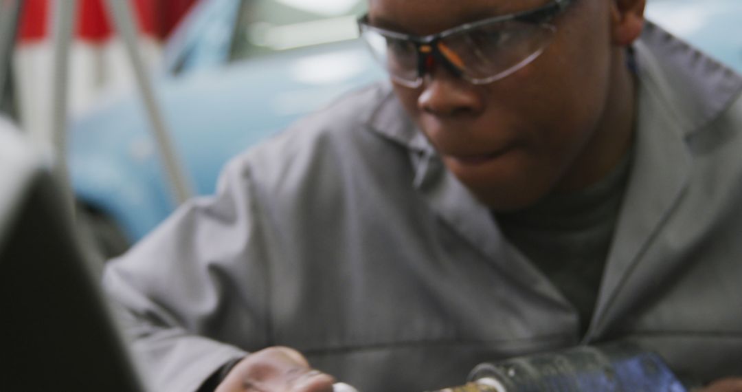 African American Mechanic Using Power Tools in Auto Repair Shop - Free Images, Stock Photos and Pictures on Pikwizard.com