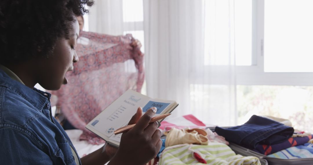 Couple Packing for Summer Vacation and Making Checklist at Home