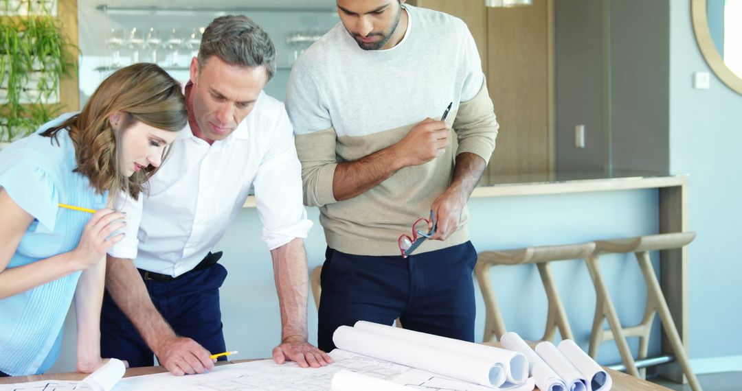 Team Collaborating on Architectural Blueprint in Modern Office