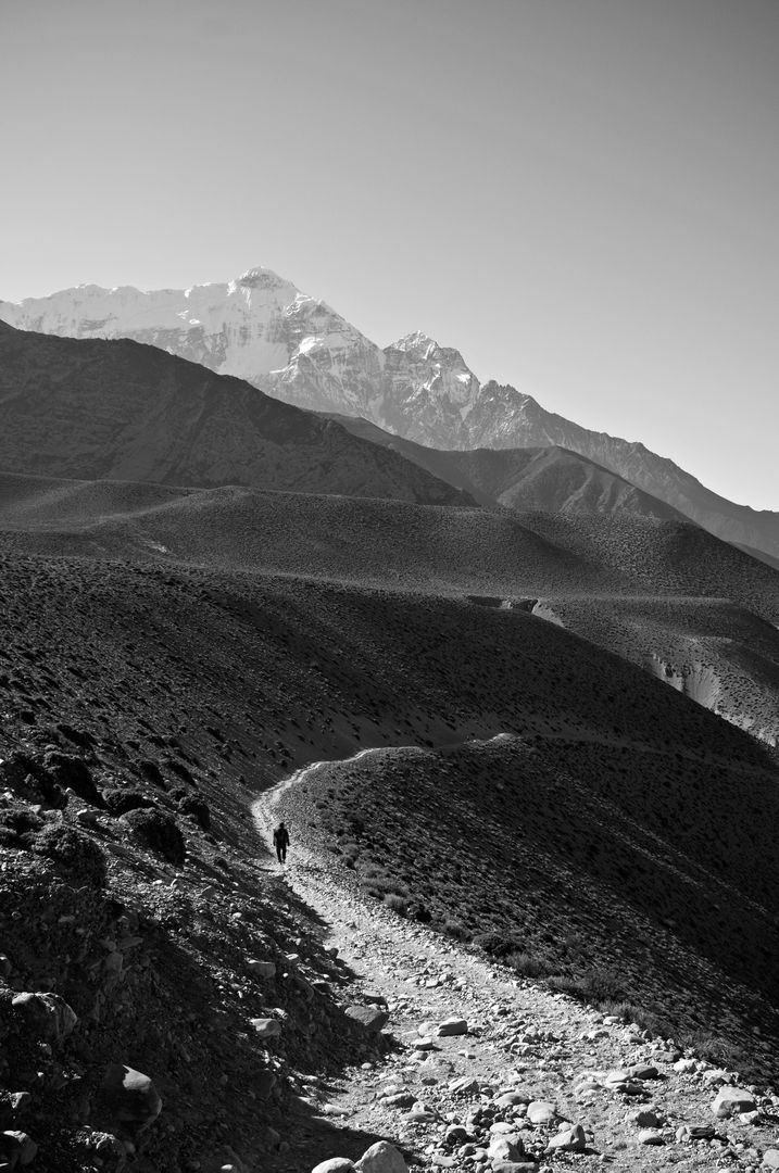 Lone Hiker on Mountain Trail in Black and White Landscape - Free Images, Stock Photos and Pictures on Pikwizard.com