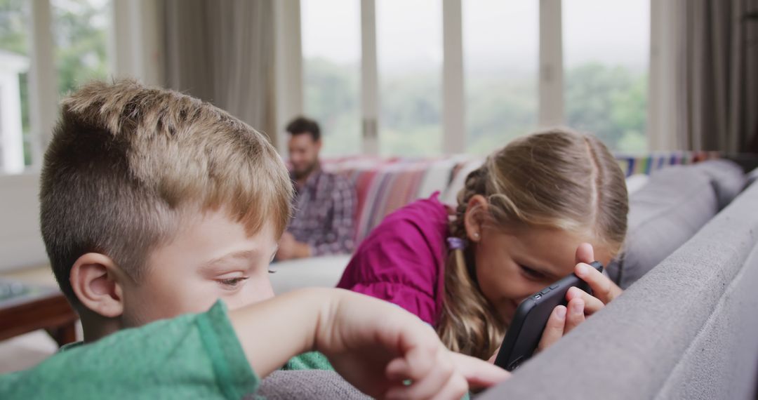 Children Playing Video Games on Tablet on Couch - Free Images, Stock Photos and Pictures on Pikwizard.com