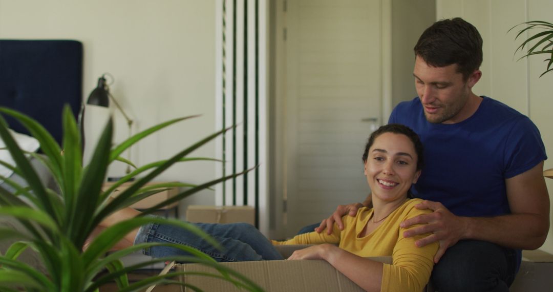 Happy Couple Unpacking in New Home Filled With Joy