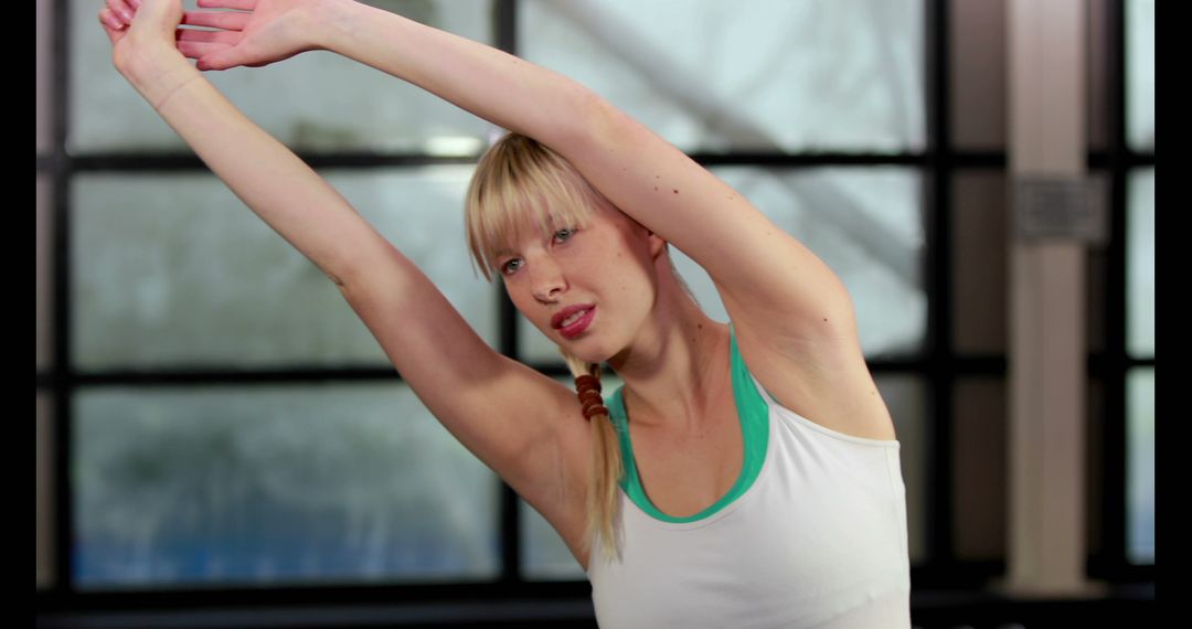 Woman Doing Side Stretches in Yoga Class - Free Images, Stock Photos and Pictures on Pikwizard.com