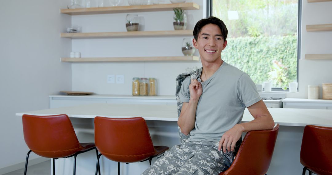Cheerful Man Relaxing in Modern Minimalist Kitchen