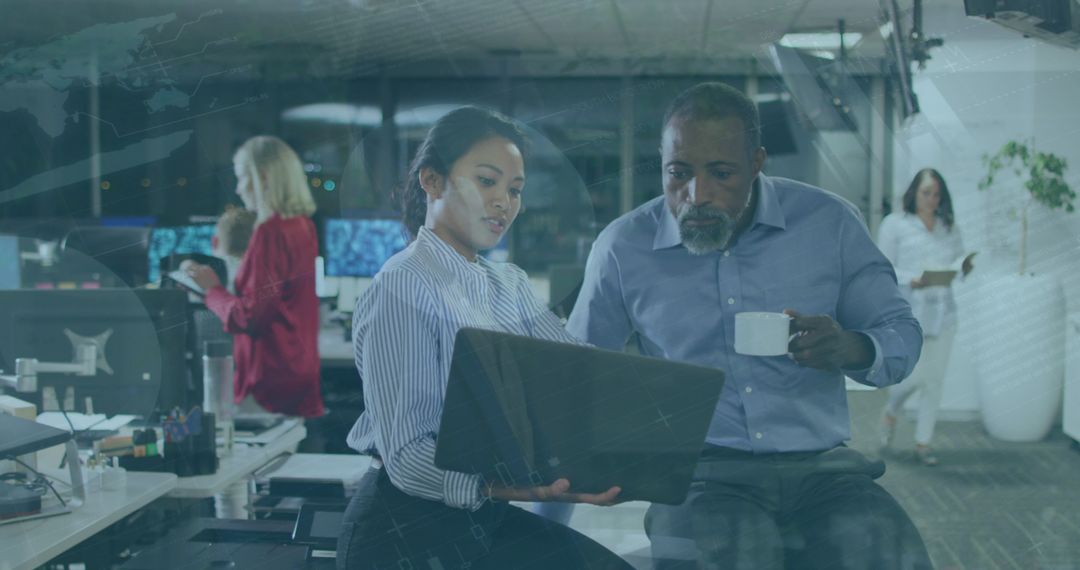Diverse Leaders Analyzing Data on Laptop in Modern Office