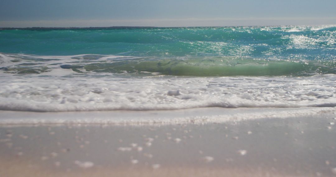 Idyllic Turquoise Ocean Waves Gently Washing Over Sandy Beach - Free Images, Stock Photos and Pictures on Pikwizard.com