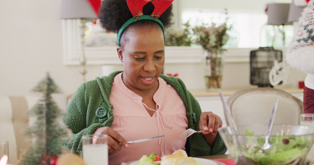 Woman with Reindeer Antler Headband Enjoying Festive Holiday Meal - Free Images, Stock Photos and Pictures on Pikwizard.com