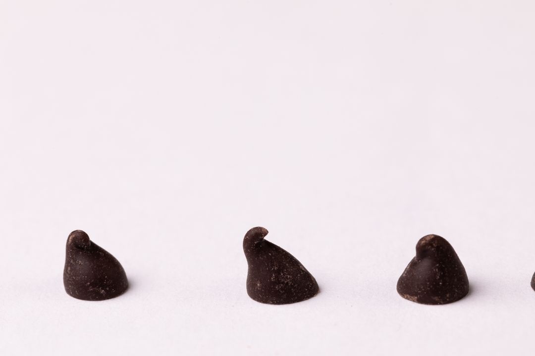 Close-up of chocolate chips on white background, copy space - Free Images, Stock Photos and Pictures on Pikwizard.com