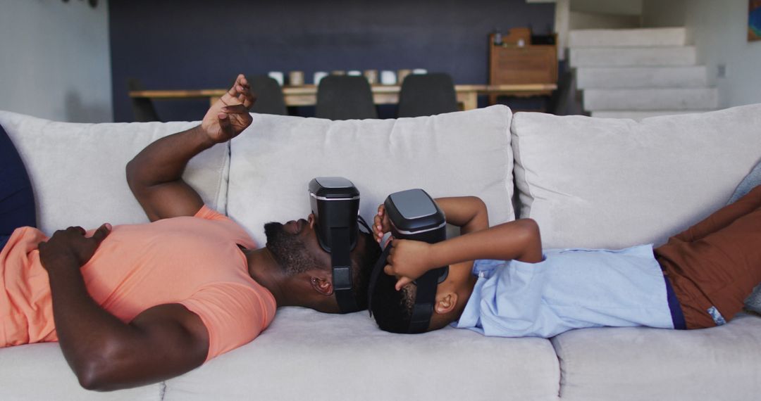 Father and Son Relaxing with VR Headsets on Couch - Free Images, Stock Photos and Pictures on Pikwizard.com