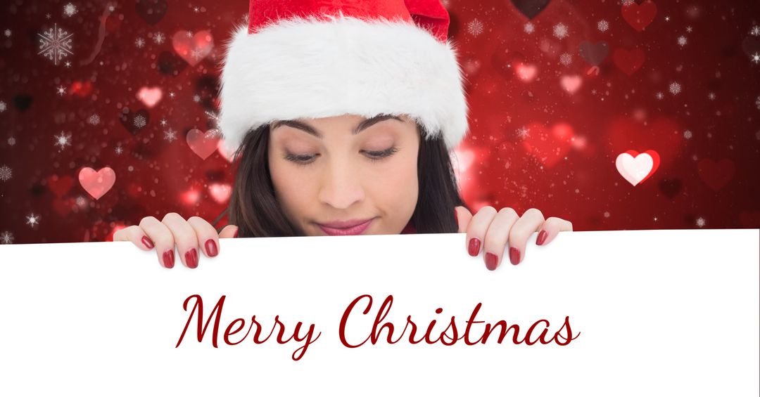 Woman Holding Merry Christmas Sign with festive Santa Hat - Download Free Stock Templates Pikwizard.com