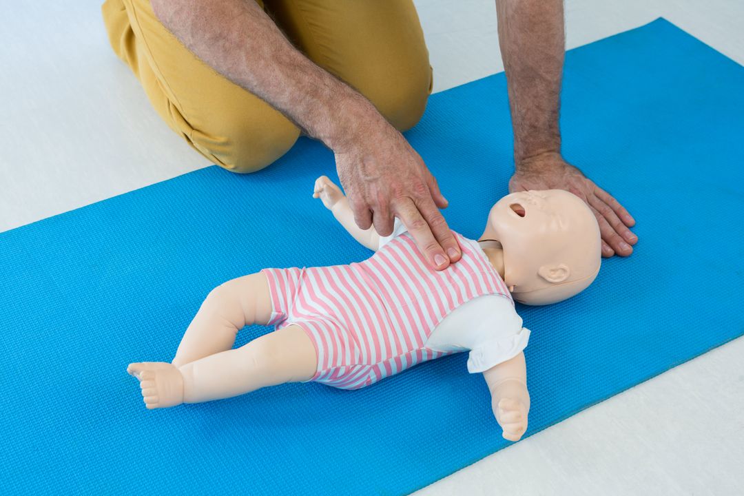 Paramedic Practicing Infant CPR on Dummy - Free Images, Stock Photos and Pictures on Pikwizard.com