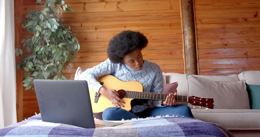 Young Woman Learning Guitar at Home with Laptop - Free Images, Stock Photos and Pictures on Pikwizard.com