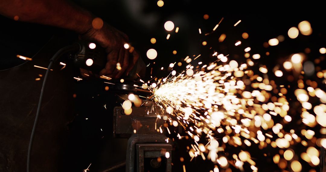 Metal grinding with bright flying sparks in workshop - Free Images, Stock Photos and Pictures on Pikwizard.com