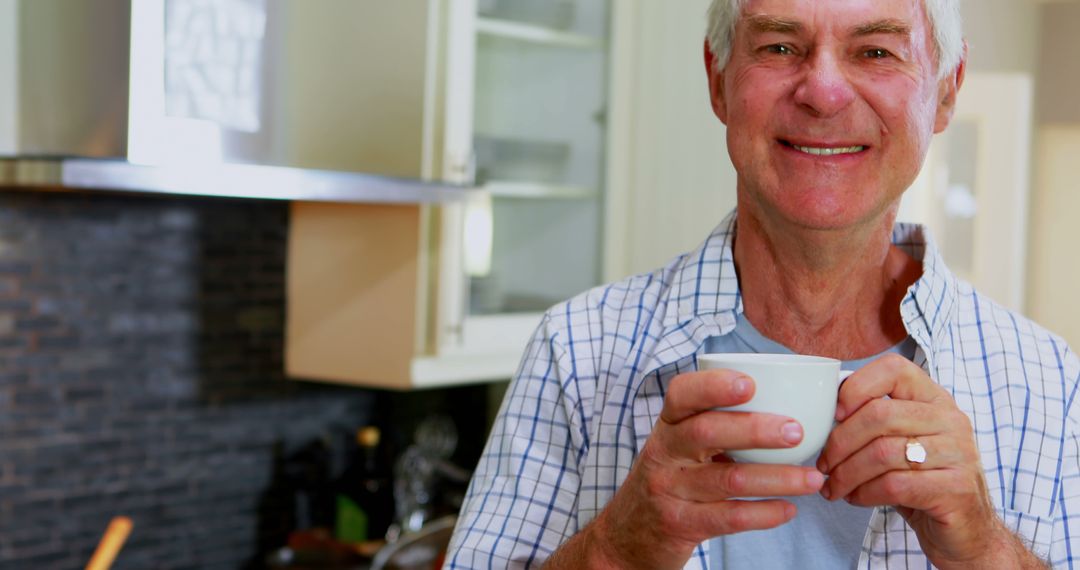 Happy Senior Man Drinking Coffee in Modern Kitchen - Free Images, Stock Photos and Pictures on Pikwizard.com