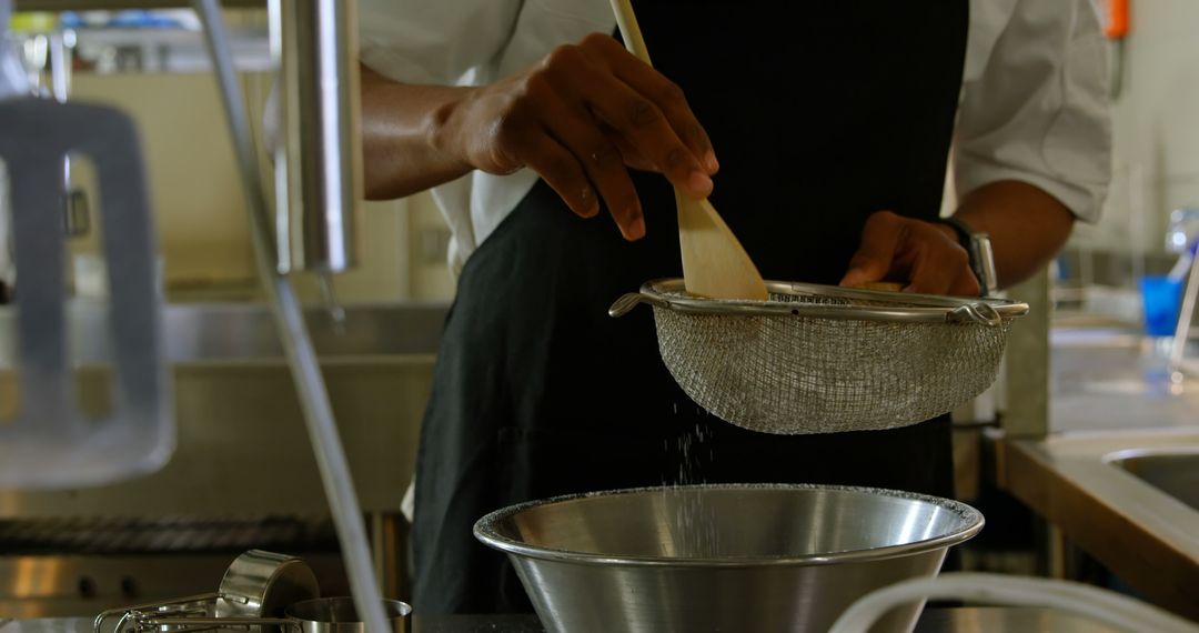 Chef Sifting Flour in Modern Kitchen for Baking Preparation