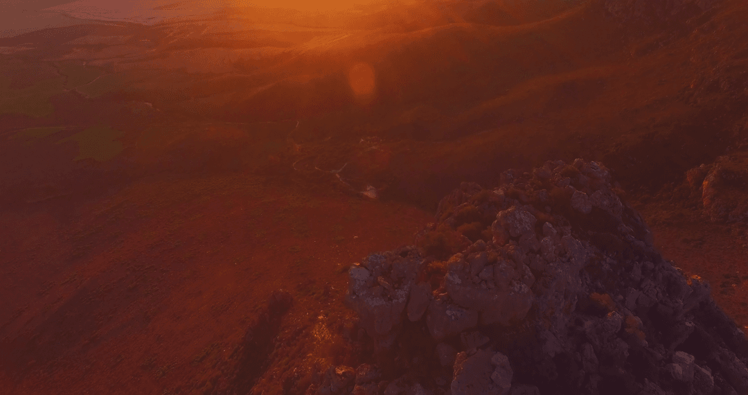 Transparent sunset over rocky terrain with vibrant hues