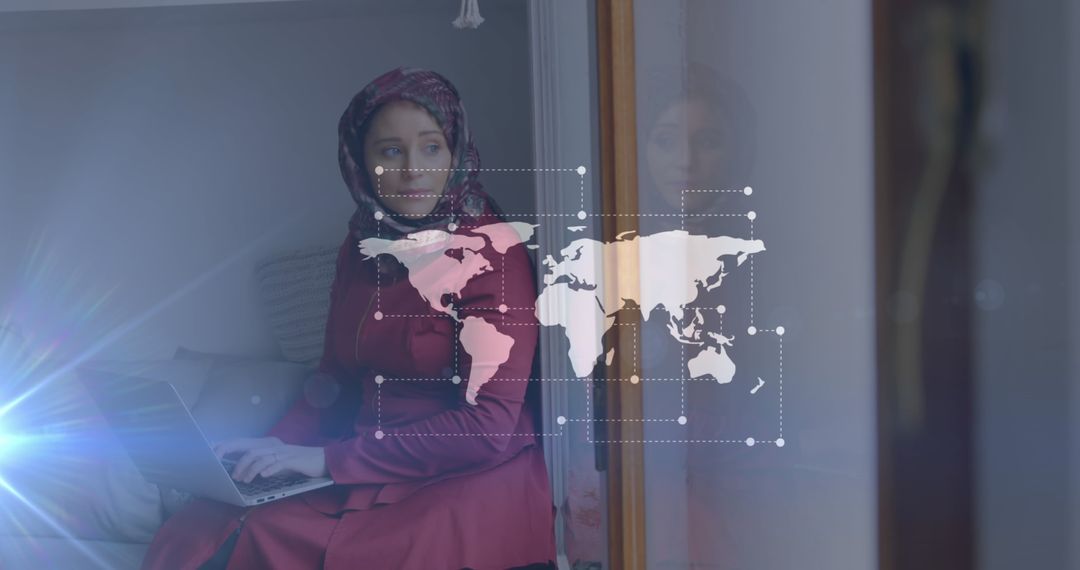 Asian Woman in Hijab Using Laptop with Digital World Map