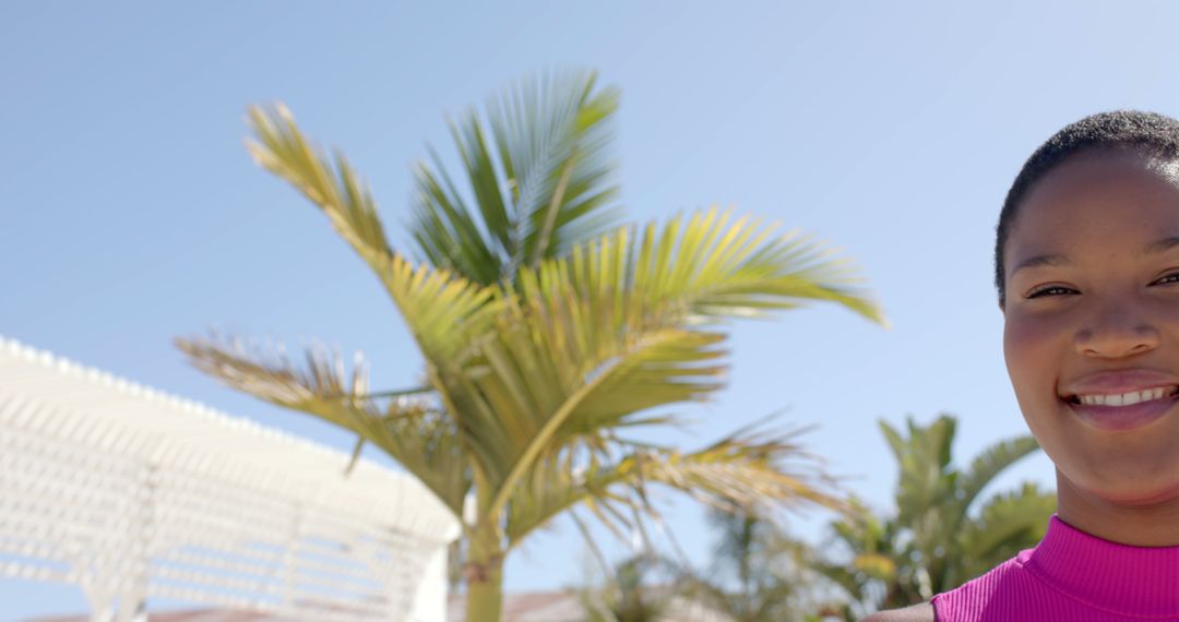 Woman Enjoying Sunny Day by Tropical Palm Tree - Free Images, Stock Photos and Pictures on Pikwizard.com