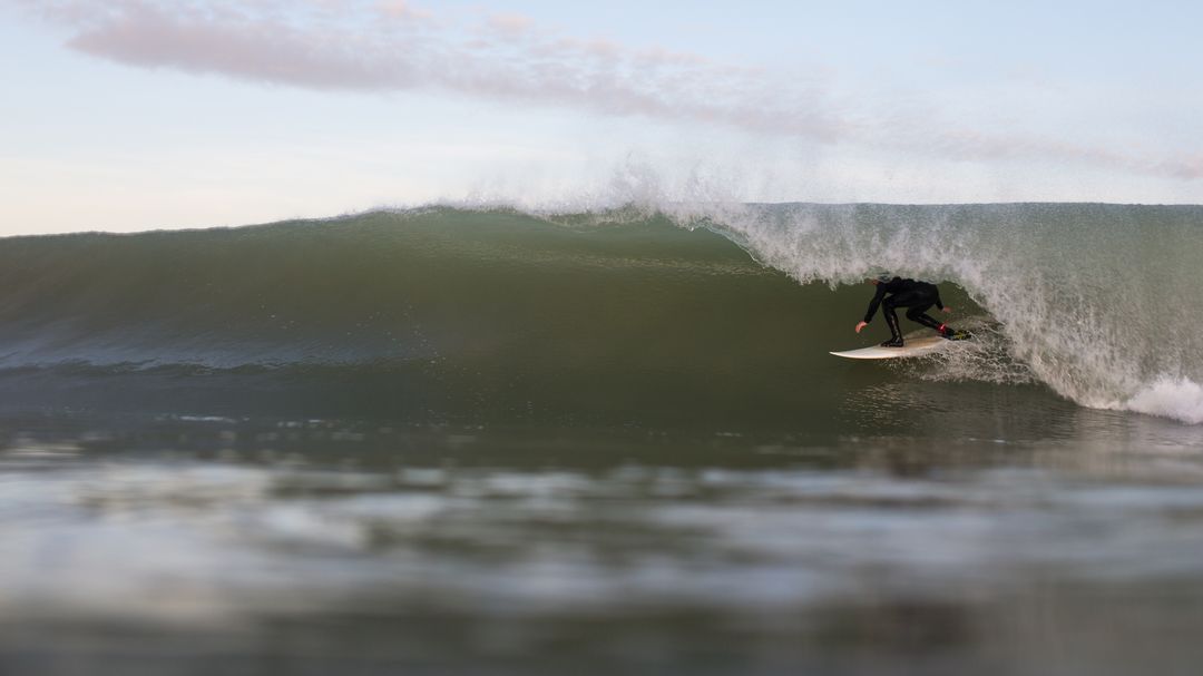 Surfer Riding Powerful Ocean Wave