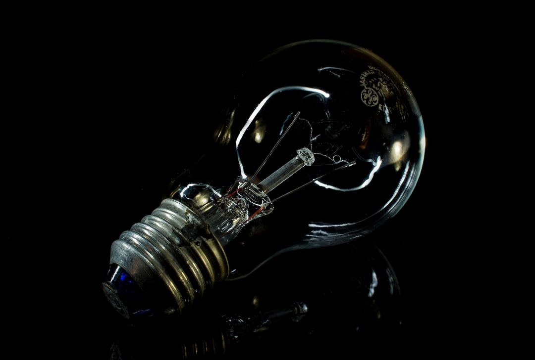Broken Light Bulb Lying on Black Background - Free Images, Stock Photos and Pictures on Pikwizard.com
