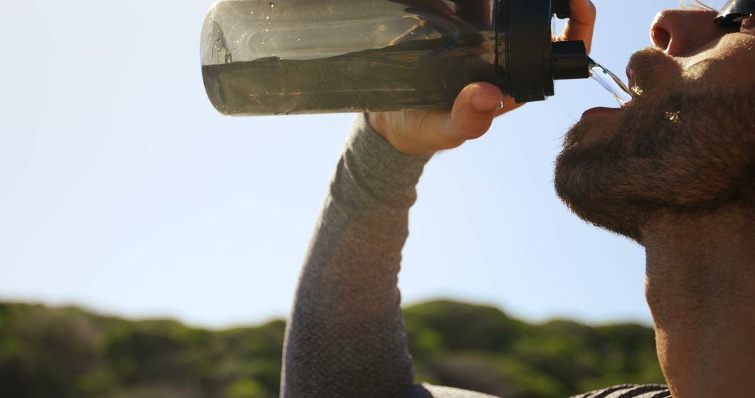 Active Man Outdoors Drinking Water Staying Hydrated
