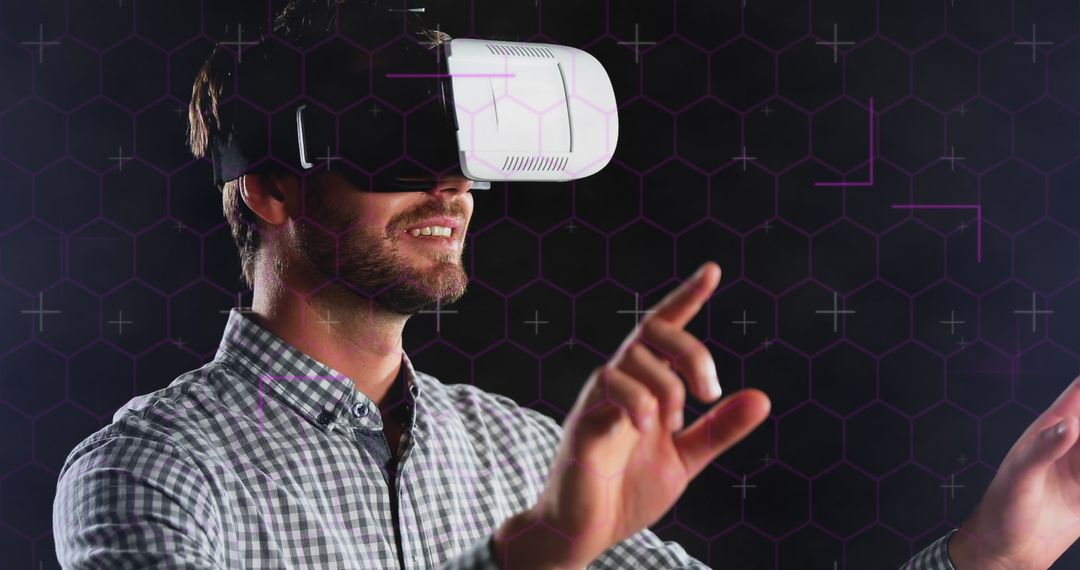 Man Engaging with Virtual Reality Interface and Hexagonal Design - Free Images, Stock Photos and Pictures on Pikwizard.com
