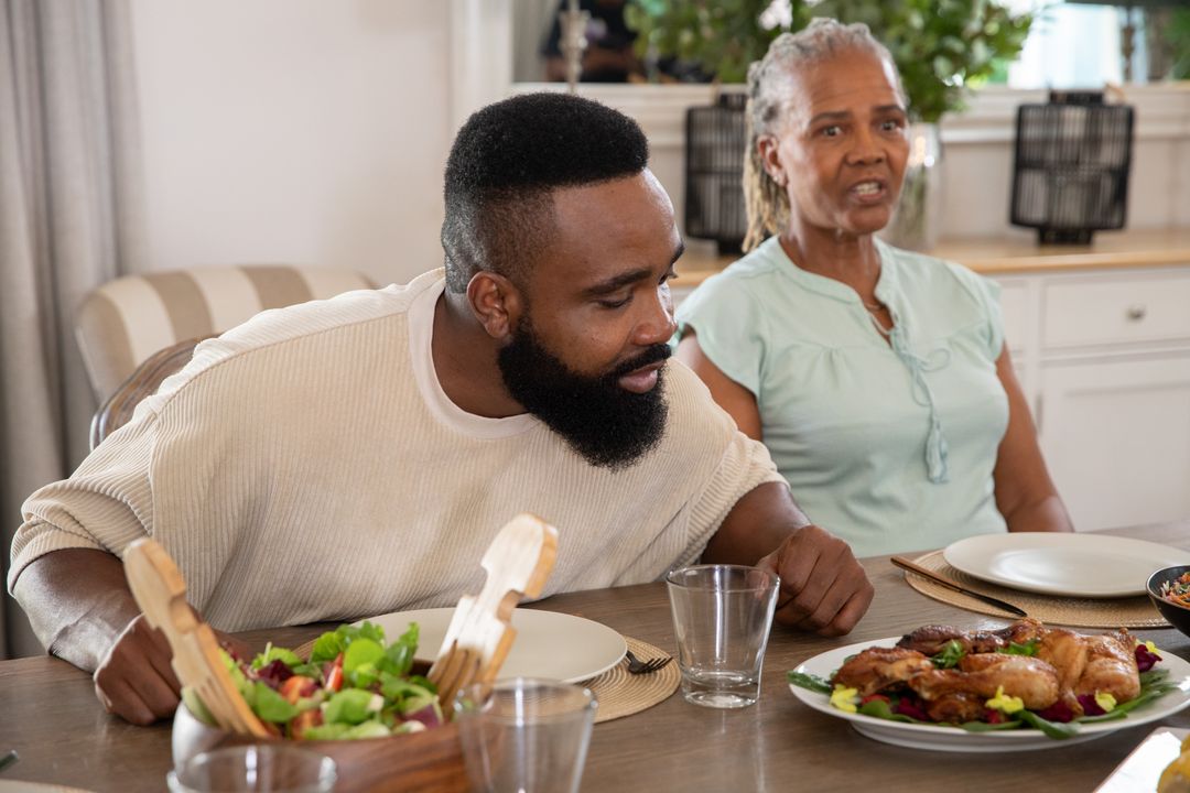 Family Enjoying Dinner Around Rustic Dining Table