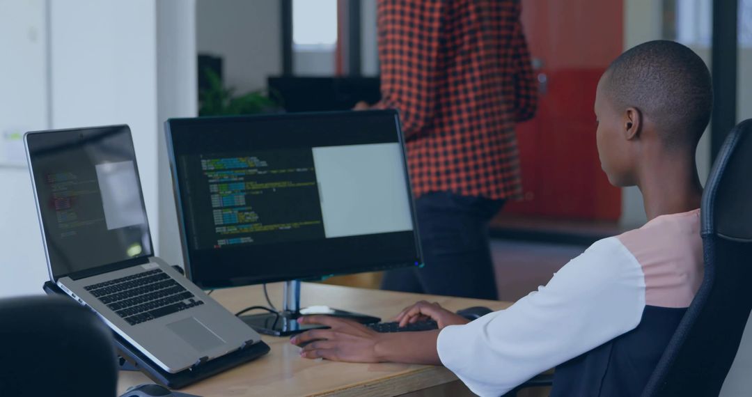 Female Developer Coding in Modern Open-Plan Workspace