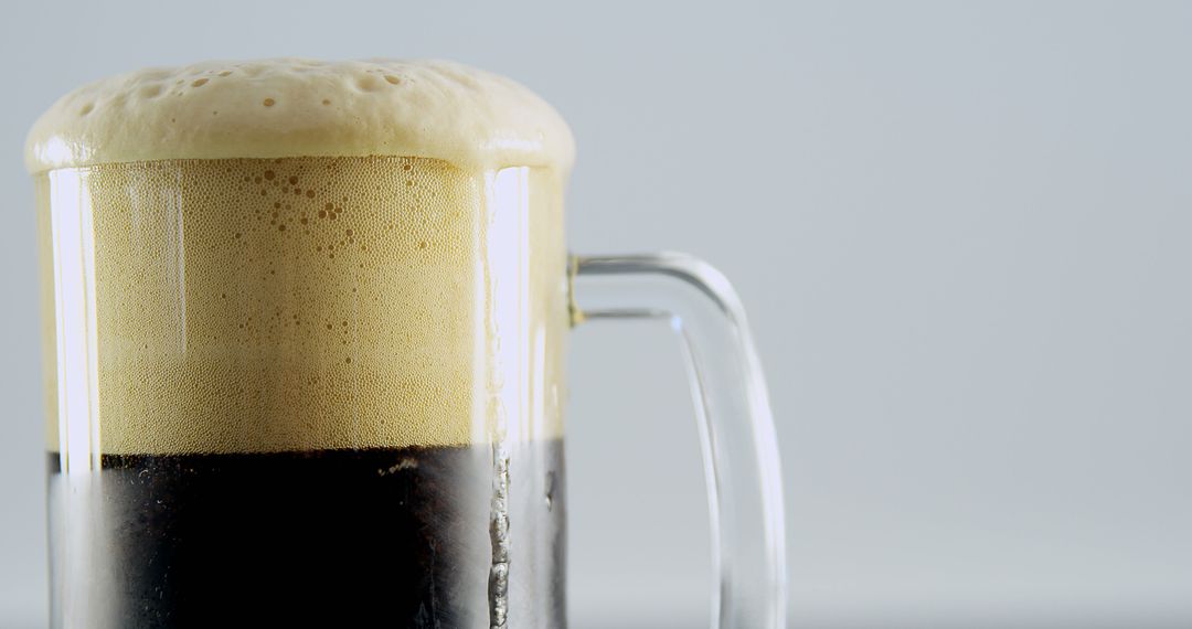 Close-Up of Full Glass of Stout Beer with Foam Overflowing - Free Images, Stock Photos and Pictures on Pikwizard.com