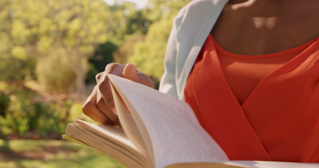 Woman Reading Book in Sunlit Garden - Free Images, Stock Photos and Pictures on Pikwizard.com