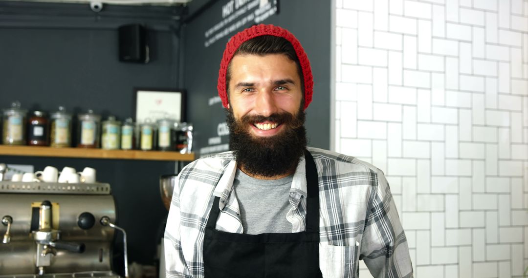 Smiling Barista Wearing Red Beanie and Apron in Modern Cafe - Free Images, Stock Photos and Pictures on Pikwizard.com