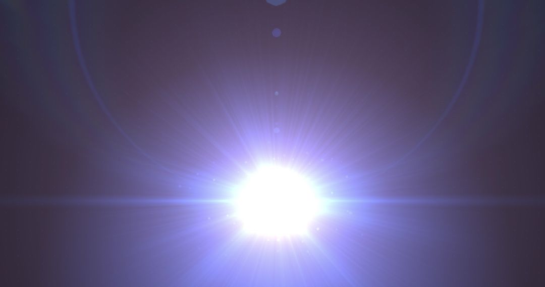 Bright Blue Light Burst in Darkness creating Lens Flare Effect