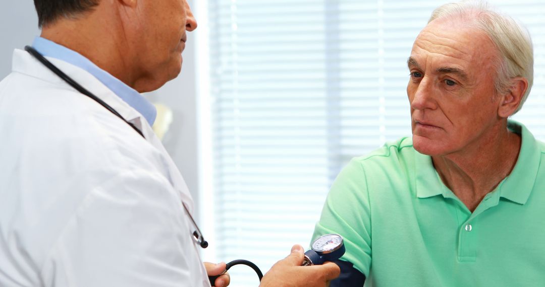 Doctor Checking Senior Man's Blood Pressure in Medical Office - Free Images, Stock Photos and Pictures on Pikwizard.com