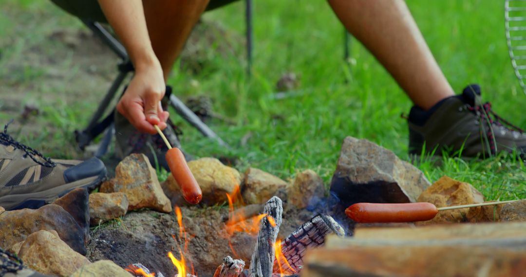 Man Camping, Roasting Hot Dog Over Campfire in Forest - Free Images, Stock Photos and Pictures on Pikwizard.com