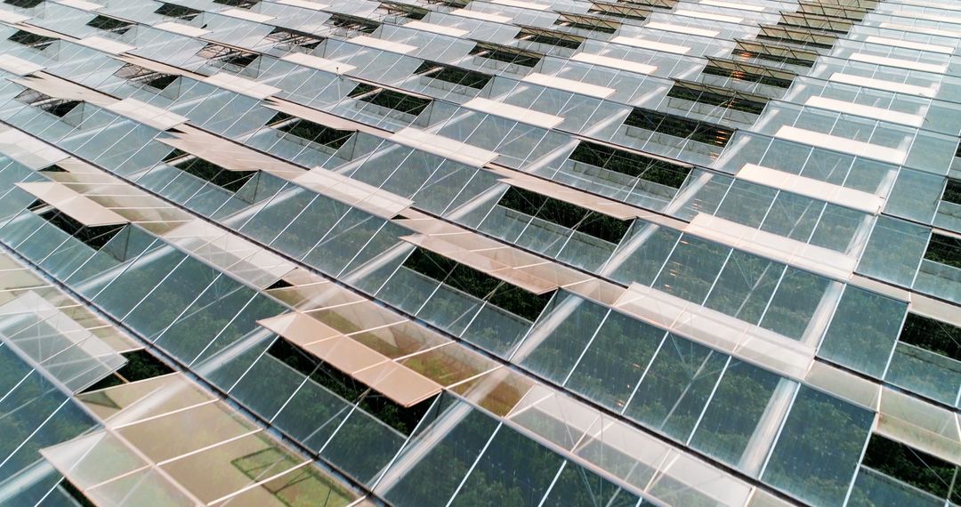 Modern building's facade features sustainable, reflective glass panels with a geometric design. - Free Images, Stock Photos and Pictures on Pikwizard.com