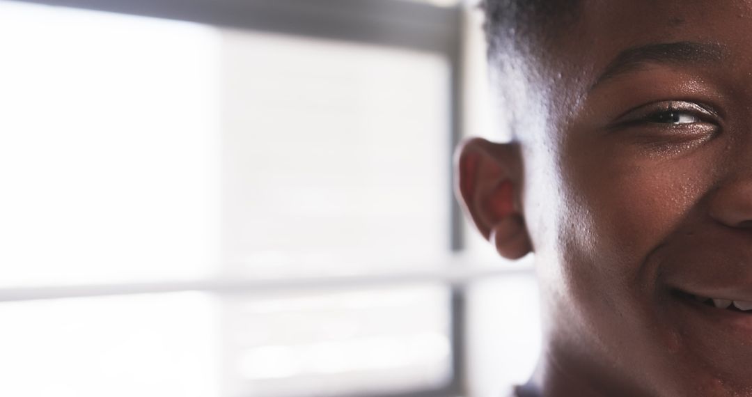 Close-Up of Smiling Teen with Blurred Window Background