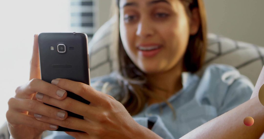 Woman Relaxing on Sofa Using Smartphone for Modern Communication