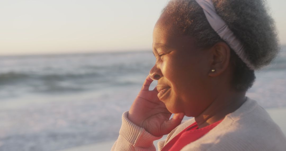 Senior Woman Enjoying Peaceful Moment at Beach Sunset - Free Images, Stock Photos and Pictures on Pikwizard.com