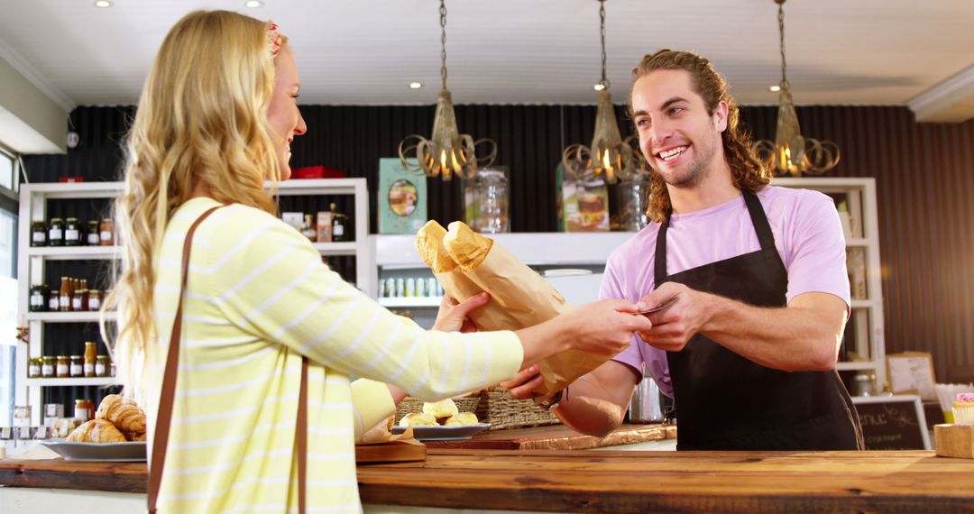 Customer Receiving Fresh Bread from Smiling Baker in Cozy Bakery - Free Images, Stock Photos and Pictures on Pikwizard.com