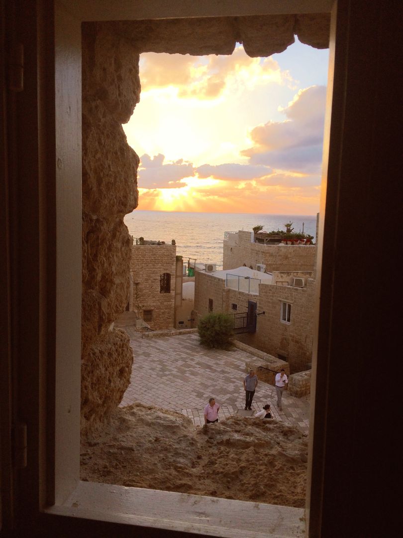 Beautiful Sunset View Through Ancient Stone Window, Coastal Town - Free Images, Stock Photos and Pictures on Pikwizard.com