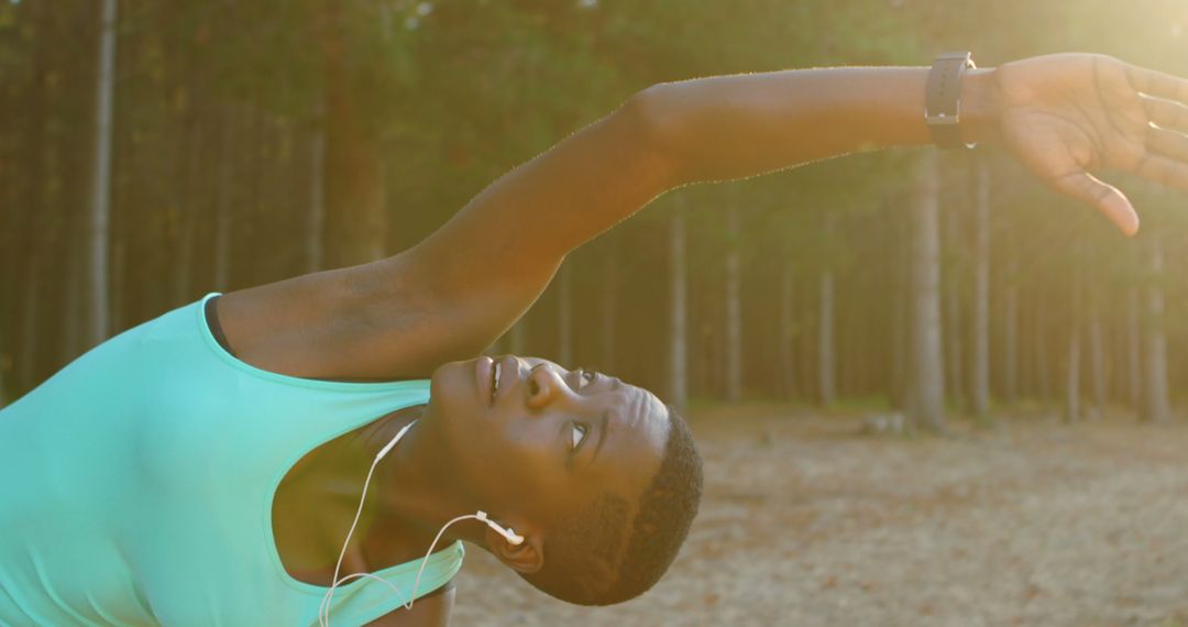 Young African American woman stretching during outdoor workout - Free Images, Stock Photos and Pictures on Pikwizard.com