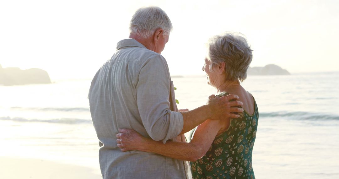 Senior Couple Embracing at the Beach During Sunset - Free Images, Stock Photos and Pictures on Pikwizard.com