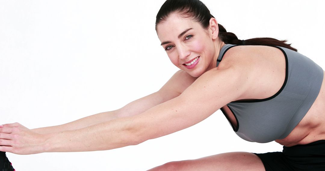 Active Woman Stretching and Smiling in Sportswear - Free Images, Stock Photos and Pictures on Pikwizard.com