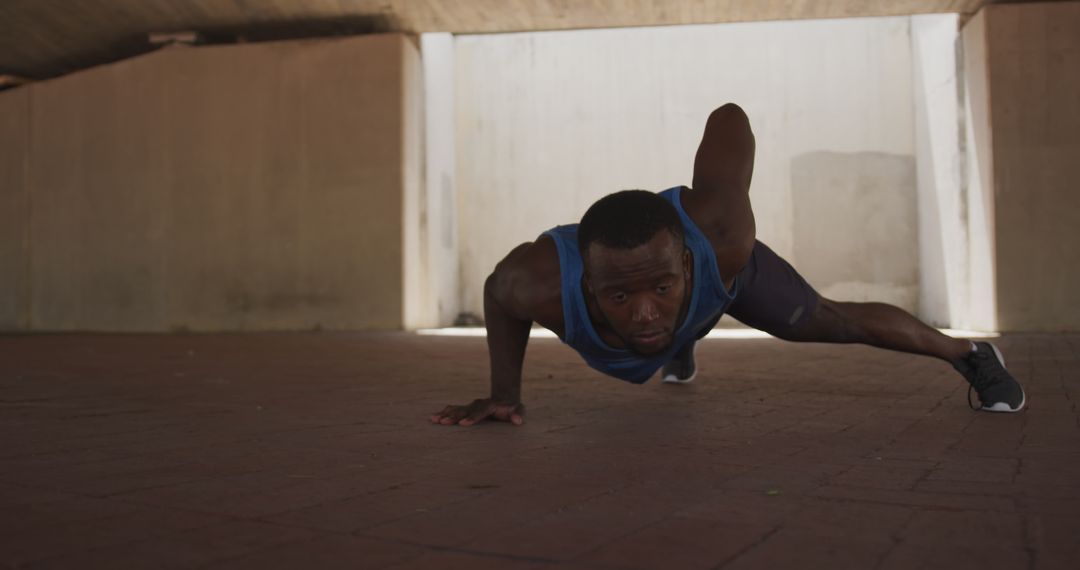 Athletic Man Doing One-Arm Push-Up Under Concrete Bridge - Free Images, Stock Photos and Pictures on Pikwizard.com